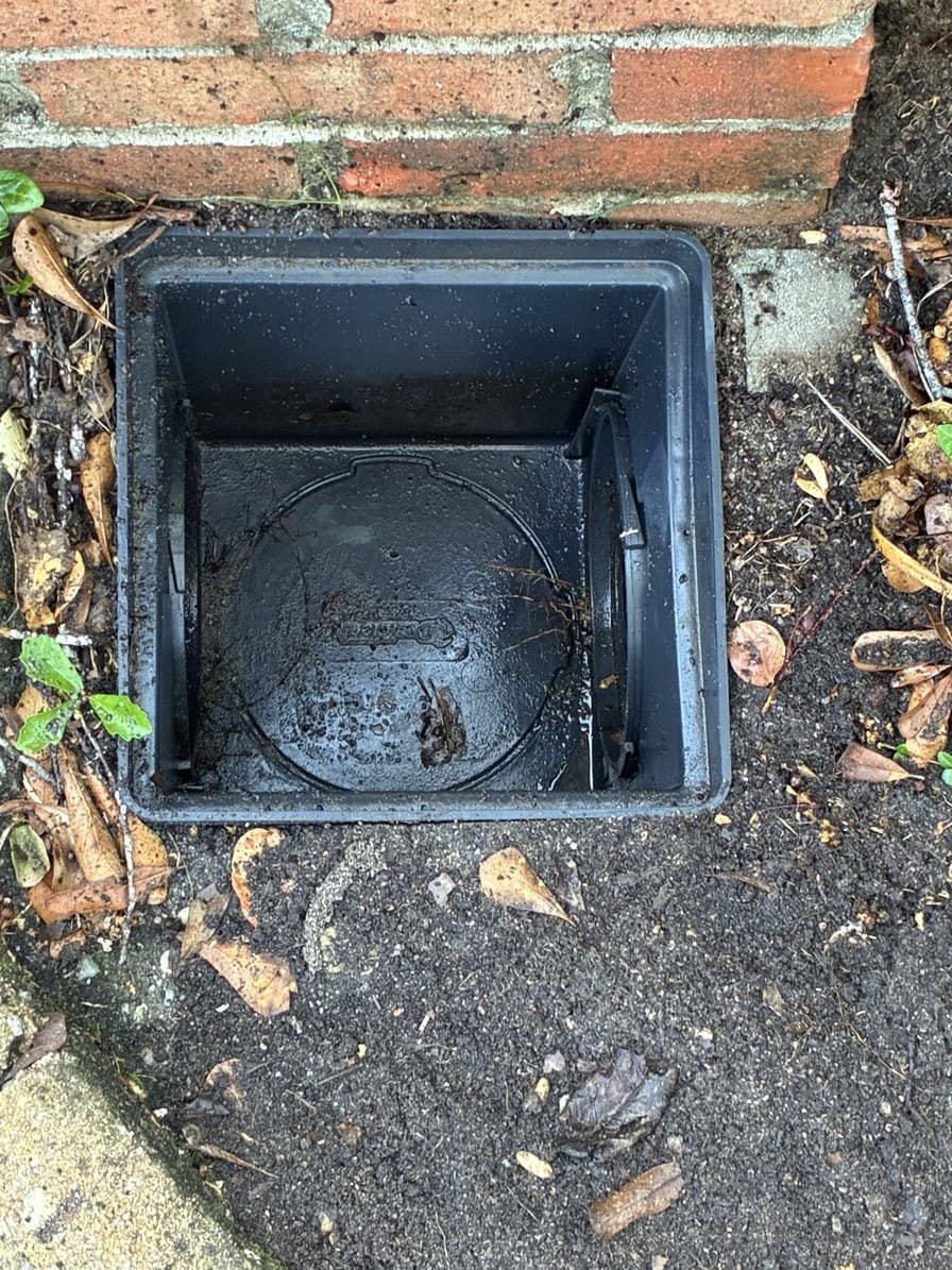 The same basin emptied to a clear throat with the outlet pipe visible at the floor