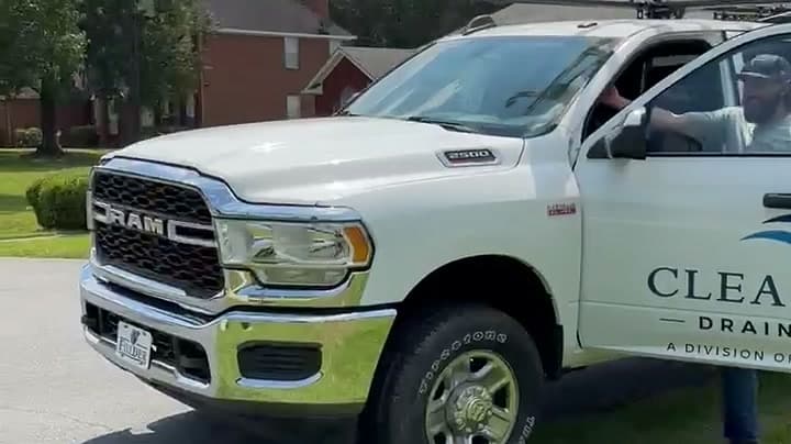 Clear Flow service truck on a job, company name and division lettering along the door