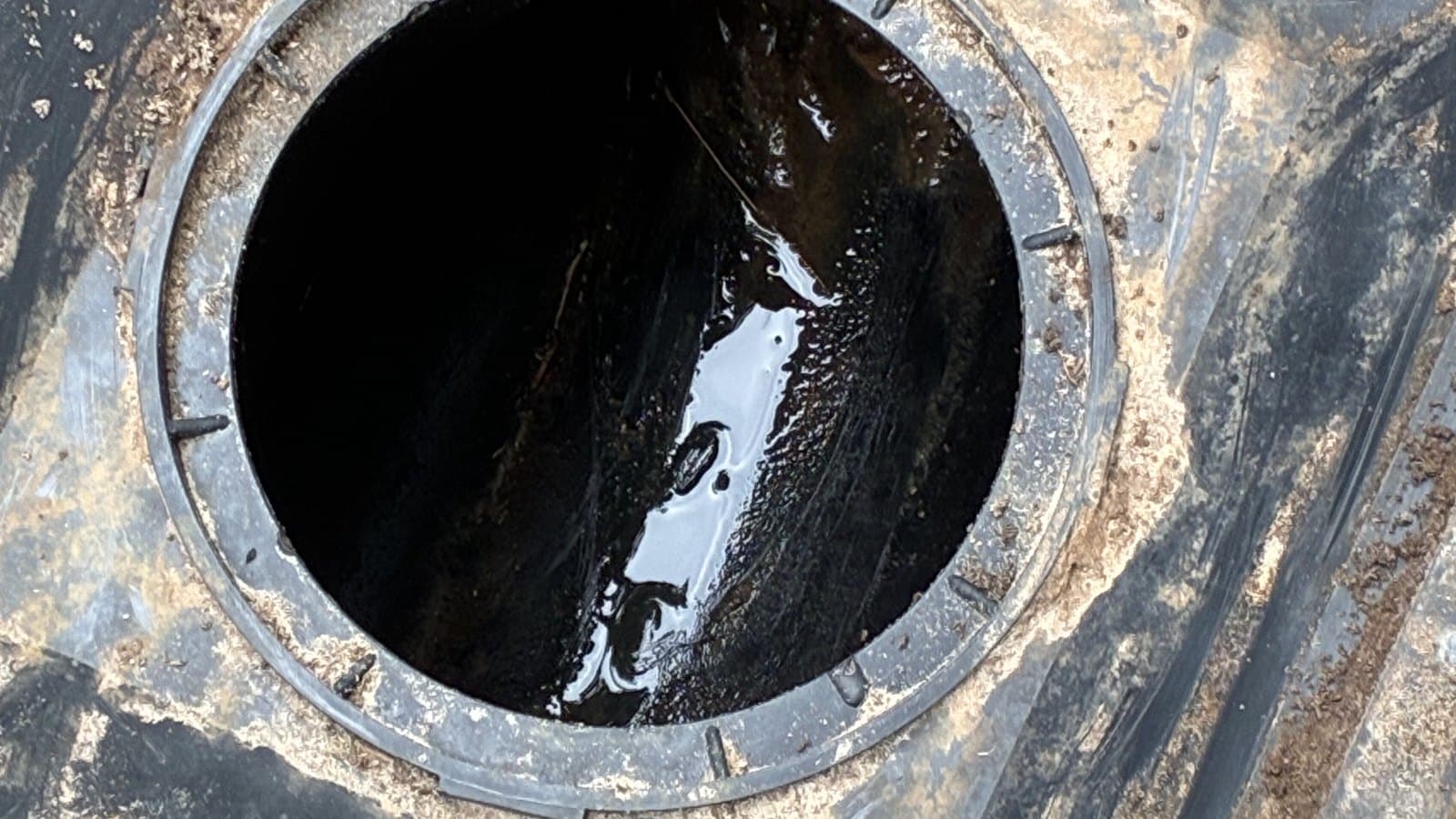 Drain box outlet scoured back to bare pipe wall with the bore standing clear